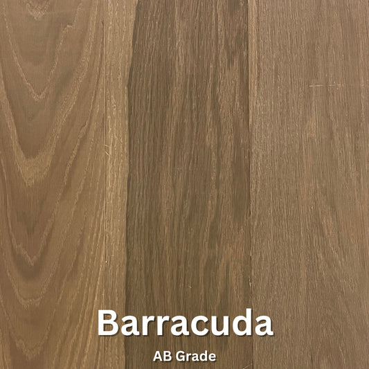 A close-up image of engineered hardwood flooring with a label indicating the wood species as 'Barracuda AB Grade'.